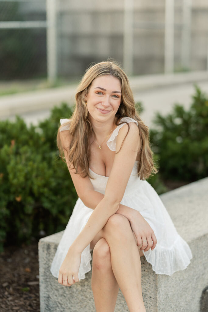 high school girl posing for her senior portraits at the lincoln memorial in washington d.c.