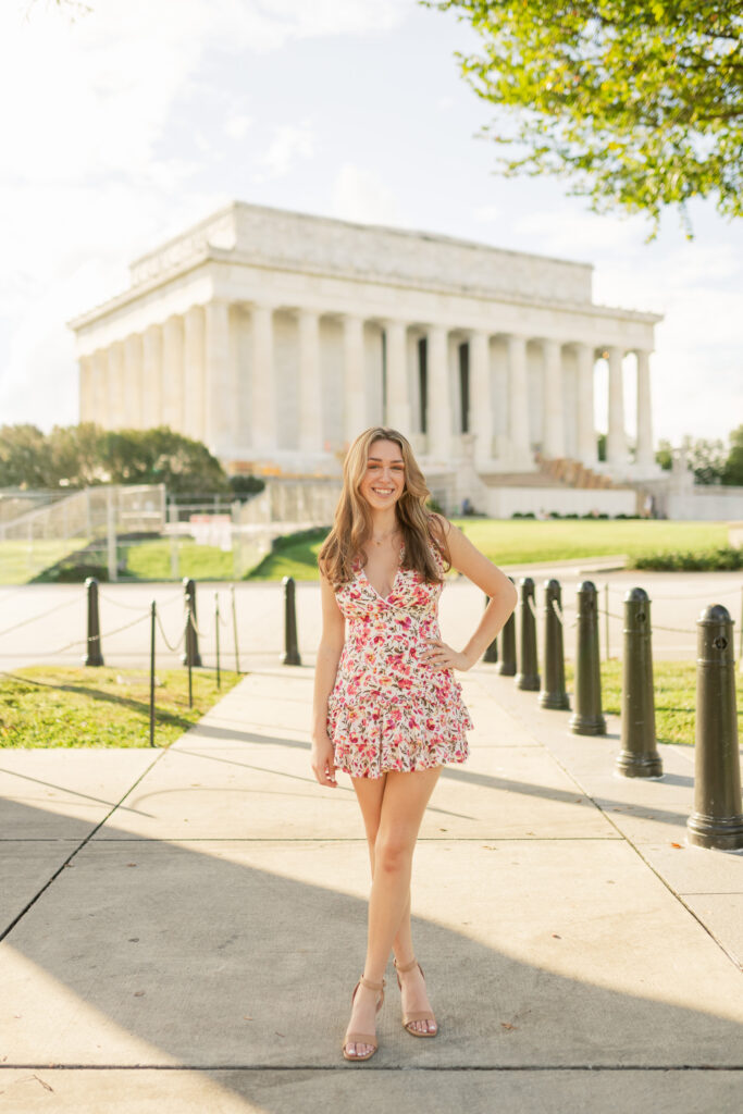 high school girl posing for her senior portraits at the lincoln memorial in washington d.c.