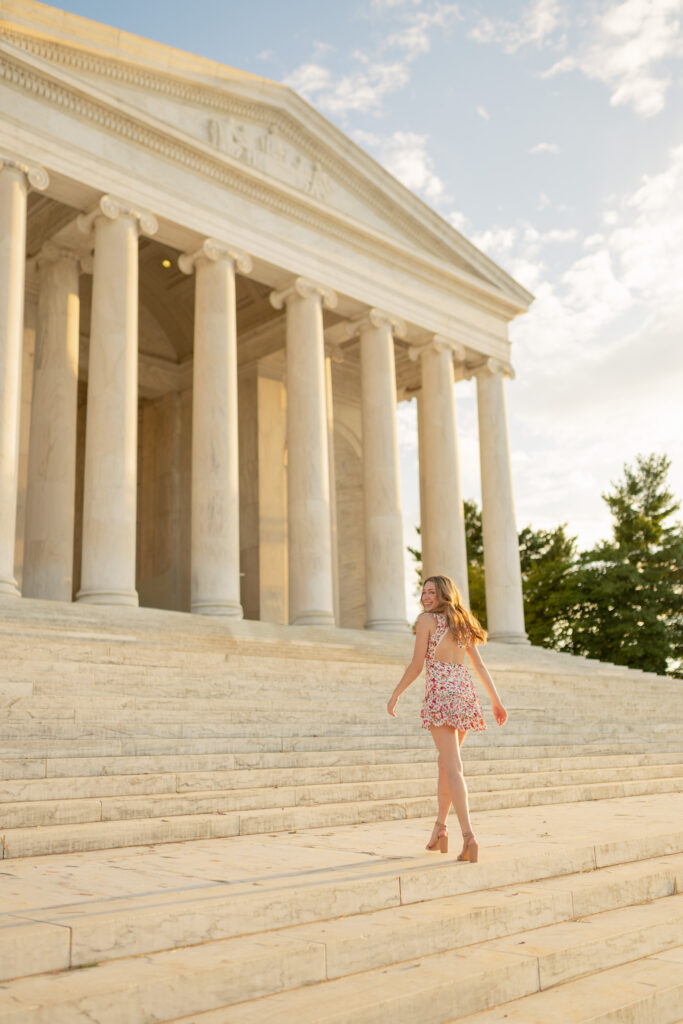 high school girl posing for her senior portraits at the Jefferson Memorial in washington d.c.