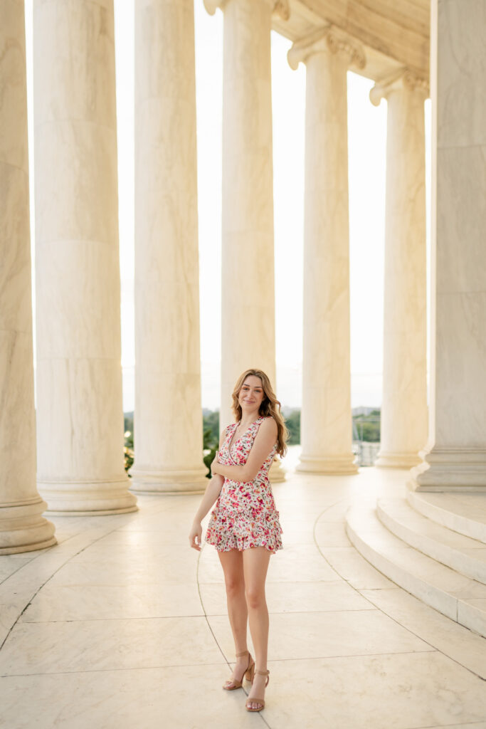 high school girl posing for her senior portraits at the Jefferson Memorial in washington d.c.